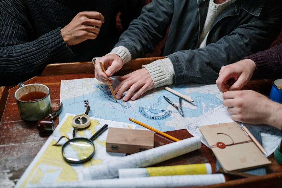 Adults planning a nautical journey using maps, compass, and tools indoors.